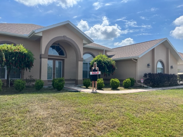 House with Sold sign in front.